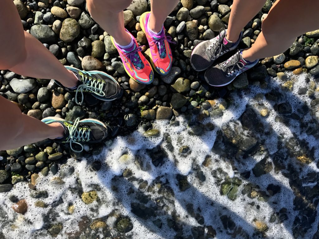 Running tennis shoes on a beach.