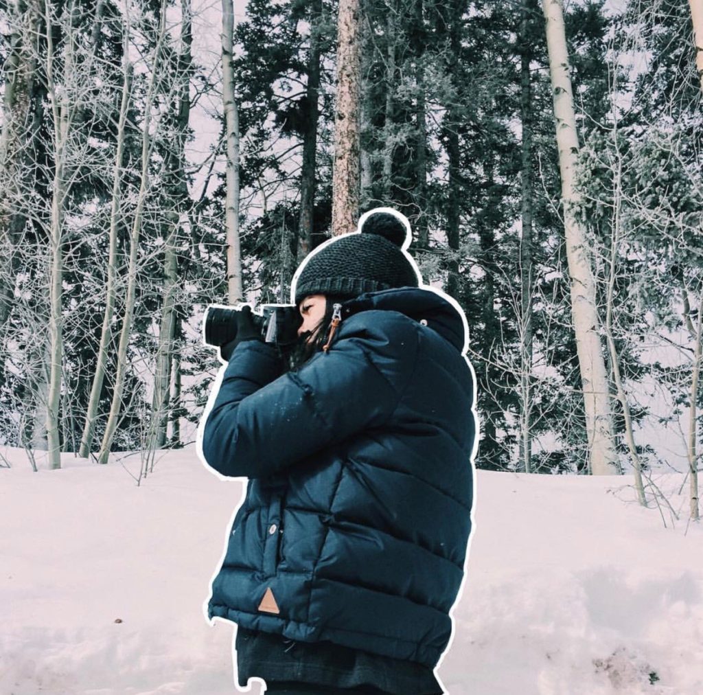 Photographer framing a shot of a winter wonderland.