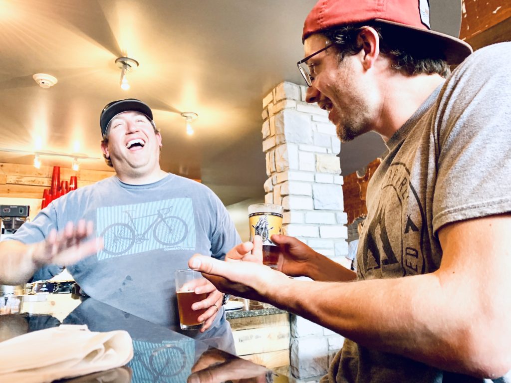 Friends having a beer at Eleanor's Pizzaria.